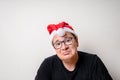 Young funny guy with christmas hat on white background. Sad santa. Christmas Royalty Free Stock Photo