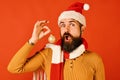 Young funny guy with red santa hat and Christmas ball Royalty Free Stock Photo