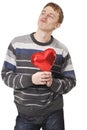 Young funny handsome man with red heart balloon