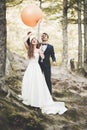 Young funny happy wedding couple outdoors with ballons Royalty Free Stock Photo