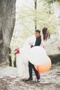 Young funny happy wedding couple outdoors with ballons Royalty Free Stock Photo