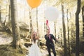 Young funny happy wedding couple outdoors with ballons Royalty Free Stock Photo