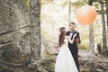 Young funny happy wedding couple outdoors with ballons Royalty Free Stock Photo