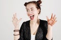 Young funny hipster woman showing tongue, shouting and surprise with funny emotion face.