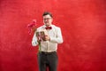 Young funny man with flowers and gift Royalty Free Stock Photo