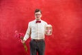 Young funny man with flowers and gift Royalty Free Stock Photo