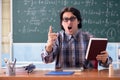 The young funny math teacher in front of chalkboard Royalty Free Stock Photo