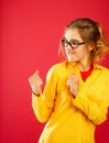 Young funny pretty woman fights over red background