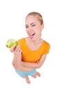 Young funny woman eat green apple Royalty Free Stock Photo