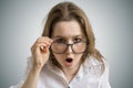 Young funny woman with glasses is shocked and surprised Royalty Free Stock Photo