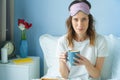 Young funny woman having a breakfast on the bed with cup of coffee Royalty Free Stock Photo