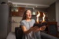 Young woman holding a wallet, wallet on fire, surprised girl, magic concept focus, wallet is burning fire