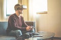 Young gamer playing video games virtual reality glasses in his apartment - Happy man having fun with new trends technology -