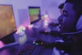 Young gamers having fun playing online video games with computer at home