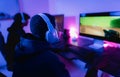 Young gamers having fun playing online video games with computer at home