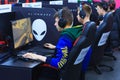 Young gamers in headphones playing at the computer