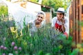 Young gardener in garden smelling flower, sunny nature Royalty Free Stock Photo