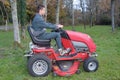 Young gardener operating garden tractor