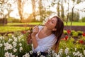 Young gardener picks daffodil flowers in spring garden. Happy woman smelling narcissus blooms cut with pruner. Gardening Royalty Free Stock Photo