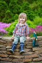 Young gardener posing on the flowerbed