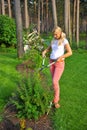 Young gardening woman trimming plant in the garden Royalty Free Stock Photo