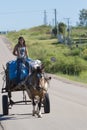 Young Gaucho woman and horse-drawn carriage on road, Uruguay