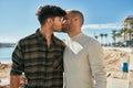 Young gay couple hugging and kissing at the beach Royalty Free Stock Photo