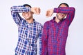 Young gay couple of two men wearing casual clothes covering eyes with arm smiling cheerful and funny Royalty Free Stock Photo