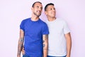 Young gay couple of two men wearing casual clothes looking away to side with smile on face, natural expression Royalty Free Stock Photo