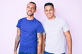 Young gay couple of two men wearing casual clothes looking positive and happy standing and smiling with a confident smile showing Royalty Free Stock Photo