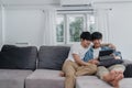 Young Gay couple using tablet at home. Asian LGBTQ+ men happy relax fun using technology watching movie in internet together while Royalty Free Stock Photo