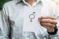 Young gay Man hand showing paper note with gender of LGBTQ symbol for Lesbian, Gay, Bisexual, Transgender and Queer community