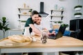 Young gays couple using a laptop together at the kitchen. Happy together, gay concept