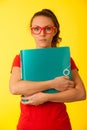 Young geek woman in red t shirt over vibrant yellow background
