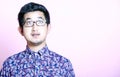 Young Geeky Asian Man in colorful shirt wearing glasses Royalty Free Stock Photo