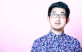 Young Geeky Asian Man in colorful shirt wearing glasses Royalty Free Stock Photo