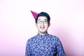 Young Geeky Asian Man wearing party hat