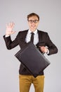 Young geeky businessman holding briefcase Royalty Free Stock Photo