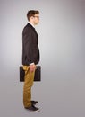 Young geeky businessman holding briefcase Royalty Free Stock Photo