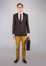 Young geeky businessman holding briefcase Royalty Free Stock Photo