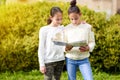 Young Generation.Two Happy Girls Reading A Book Together At Sunny Day. Royalty Free Stock Photo