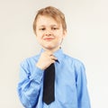 Young gentleman tying tie over bright shirt Royalty Free Stock Photo