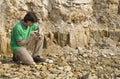 Young geologist studying rock type