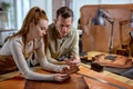 young ginger girl checking a quality of a leather piece.