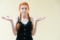 Young ginger woman posing on yellow background Royalty Free Stock Photo