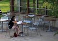Young girl in abandoned street cafe of University of Minnesota campus.