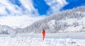 A young girl admires the winter landscape on the lake. Beautiful lake Amut in taiga hills on Far East of Russia in early Royalty Free Stock Photo