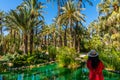 A young girl is admiring palm groves at Huerto del Cura garden in Elche Royalty Free Stock Photo