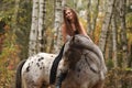 Young girl with appaloosa horse in autumn Royalty Free Stock Photo