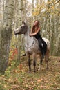 Young girl with appaloosa horse in autumn Royalty Free Stock Photo